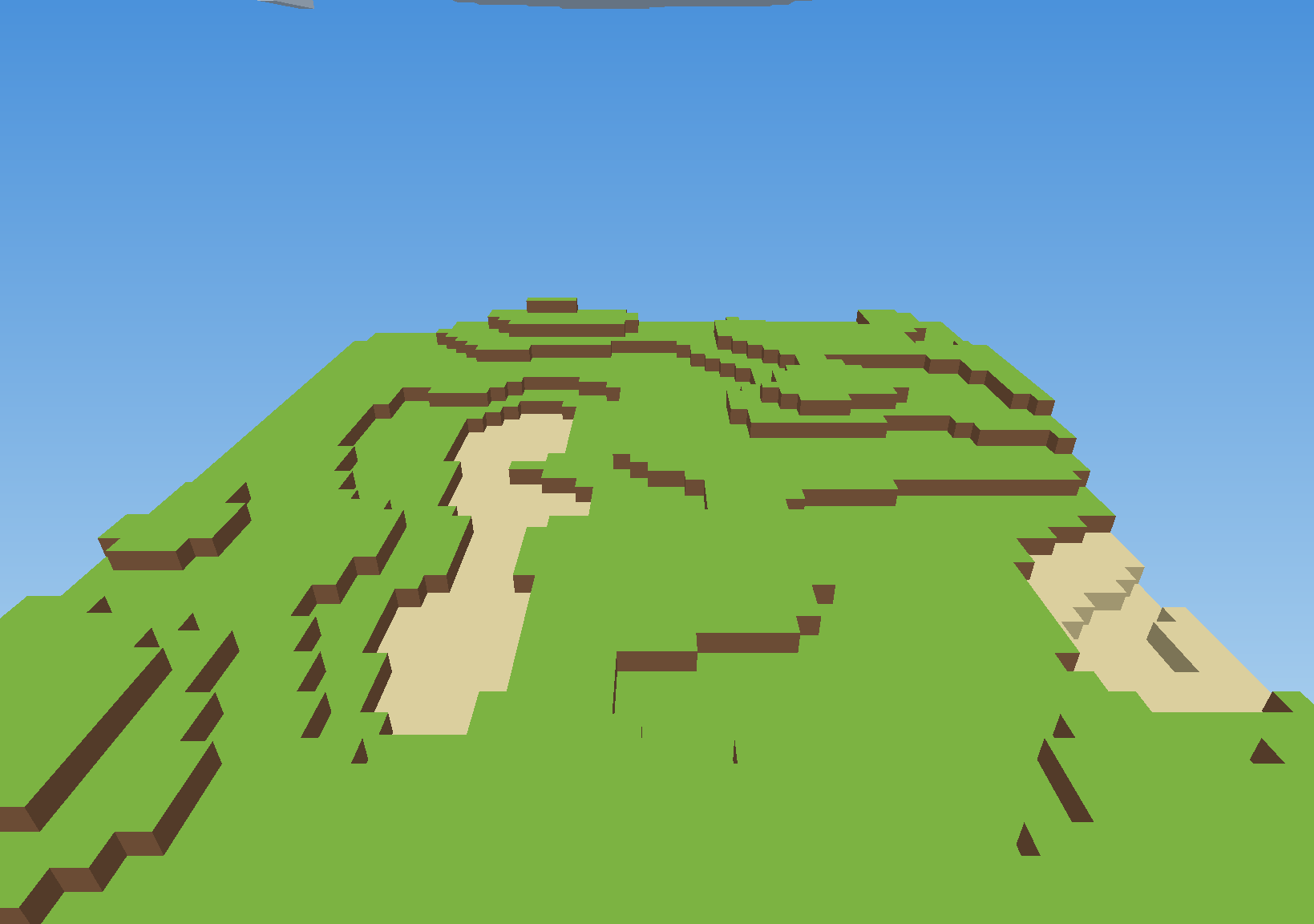 A voxel landscape of grass and sand under a blue sky